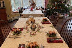 Christmas Eve tables set with shrimp appetizer.
