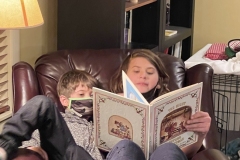 Sam reading "Twas the Night Before Christmas", helped by Jude