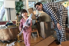Luca openinng present while dad watches