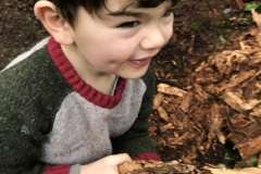 Luca grabs a chunk of wood