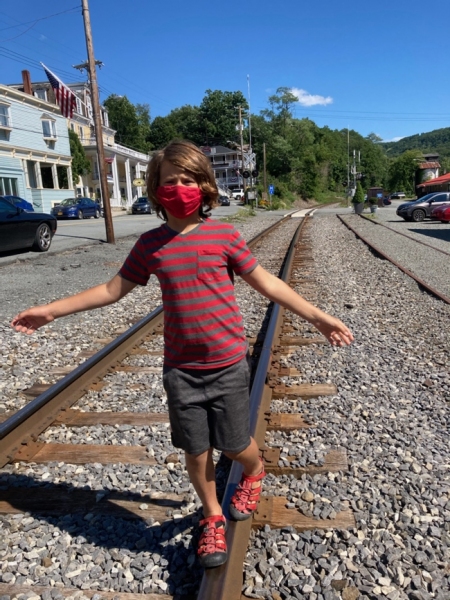 Masked man, walking the rails