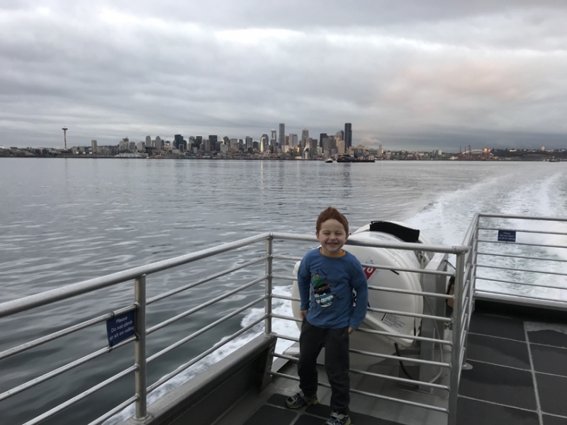 Emmett on the ferry with Seattle in the background