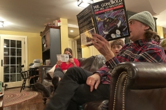 Austin reads while Jude looks on.